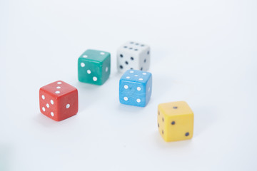 colored playing dice in a chaotic manner on a white background
