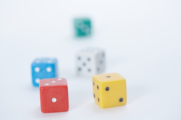 colored playing dice in a chaotic manner on a white background