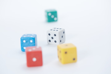 colored playing dice in a chaotic manner on a white background