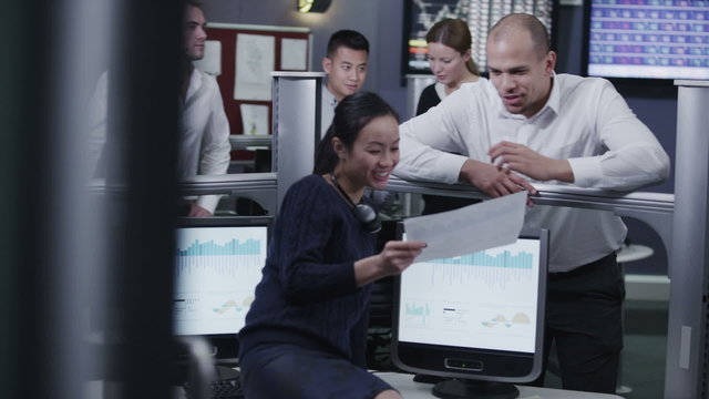 Busy team of financial traders  working together and watching the world markets