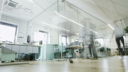 Time lapse of creative young professionals at work in busy modern office - Powered by Adobe