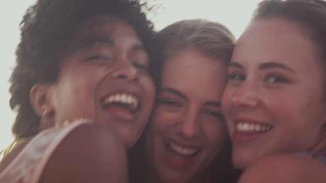 Mixed racial group of friends smiling for a selfie 