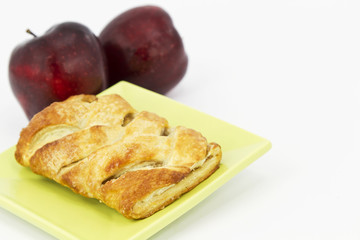 Delicious apple strudel on green plate