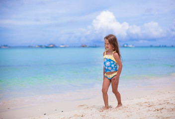 Fototapeta premium Adorable little girl have fun at tropical beach during vacation