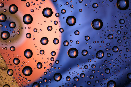 Water drops on plastic surface with refracted image