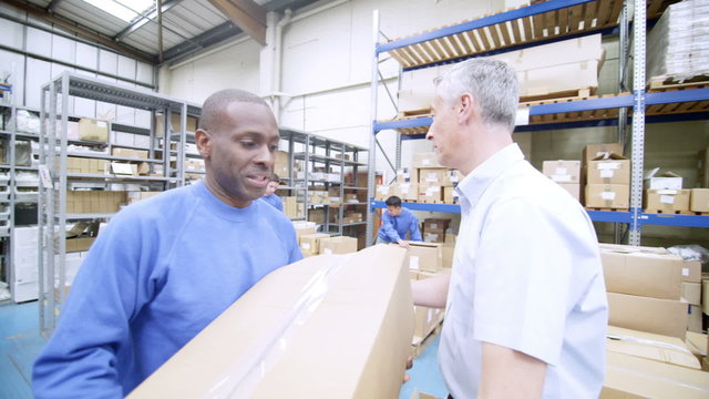 Team of male workers in warehouse or factory