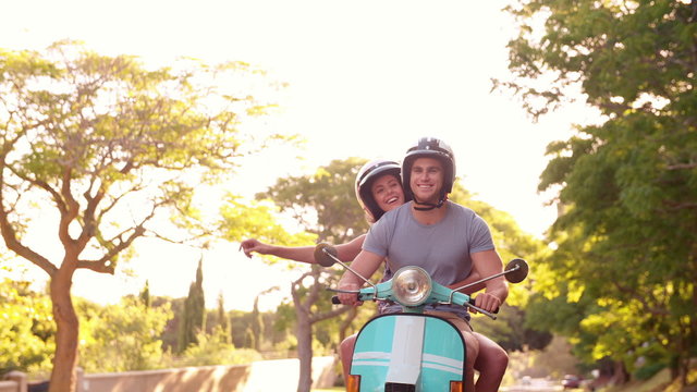 Couple road tripping on their scooter feeling free