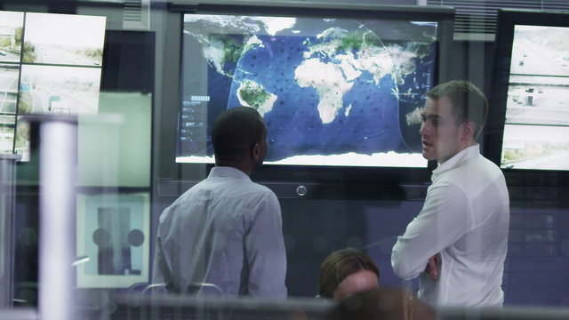 Security team watching the screens in control center office