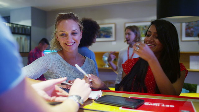 Helpful staff dealing with customers at business reception area - Powered by Adobe