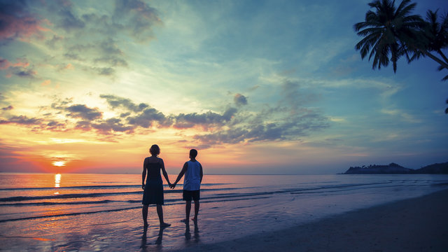 Young couple on their honeymoon standing on Sea beach.