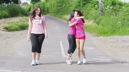 Cheerful group of female friends taking part in charity fitness event
