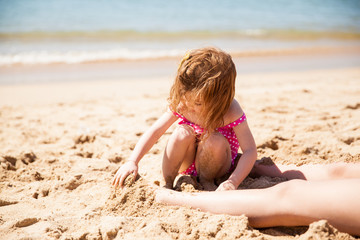 Little girl playing with sand