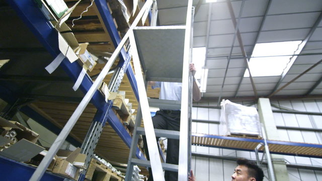 Team of male workers in a warehouse or factory