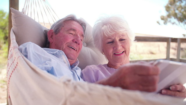 Senior couple enjoying their digital tablet together in their retirement