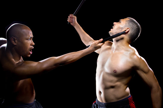 two men sparring with Filipino stick fighting martial arts