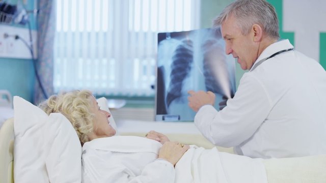 Doctor discussing x-ray results with female patient