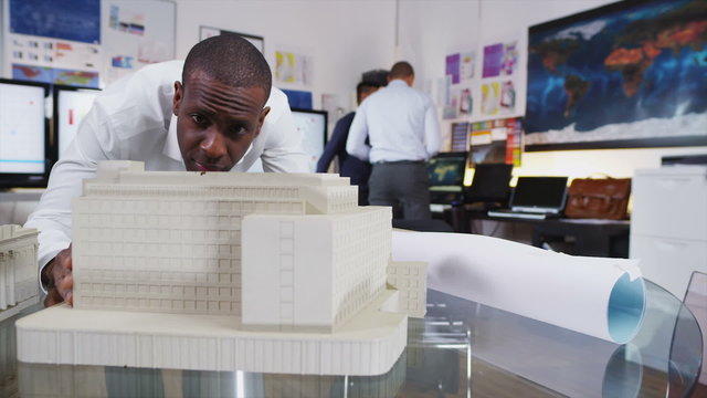 Male architect or engineer looking at concept models of new development