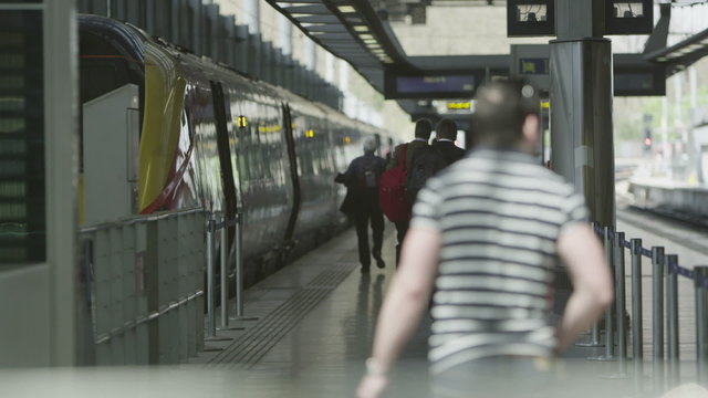 Travelers and commuters on the platform at St