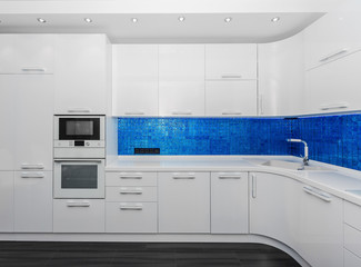 Specious modern white blue interior kitchen-dining room
