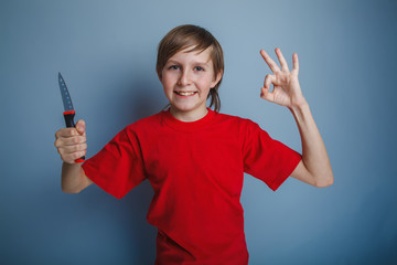 boy teenager European appearance in a red shirt holding a brown