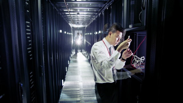 Time lapse of IT engineers working in a data centre