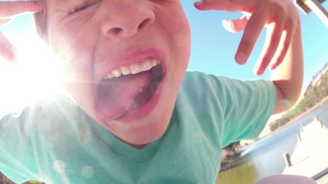 Little boy pulling a face and sticking tongue out