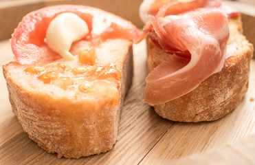 Two tapas with tomato, garlic and jamon closeup