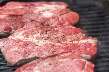 Fresh beef steaks on grill or BBQ