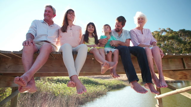 Three generation family relaxing together on a jetty