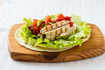 Lettuce wrapped chicken fajitas served  on a flour tortilla