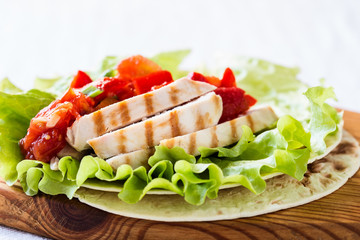 Lettuce wrapped chicken fajitas served  on a flour tortilla