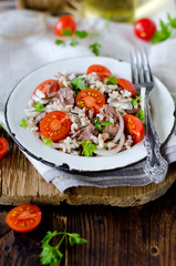 Rice with cod liver and tomatoes