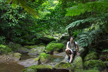 Outdoor adventure in tropical rainforest full of lush greenery ready to explore in Iriomote-jima,...