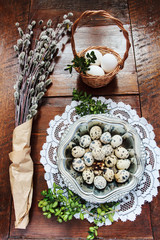 Easter composition of catkins and eggs on wooden table