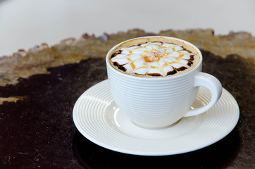 A cup of coffee with flower pattern