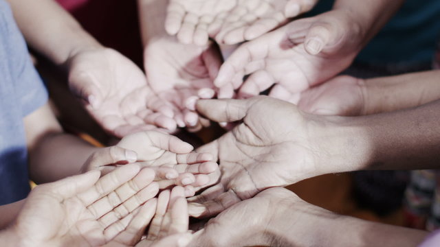 Many hands reaching out, begging for food or money