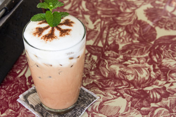 Ice coffee with whipped cream on a table
