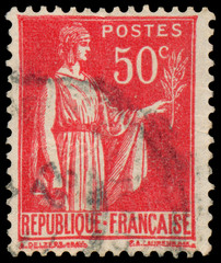 Stamp printed in France shows a woman with Olive Branch