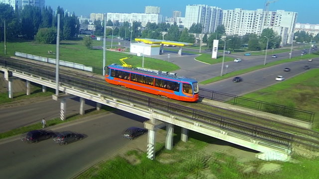 Aerial panorama follow track shot of modern new tram rides