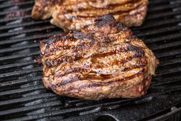 Beef steaks on grill or BBQ