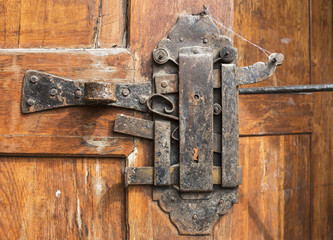 Historical padlock on the wooden door