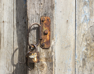 Old padlock on the wooden door