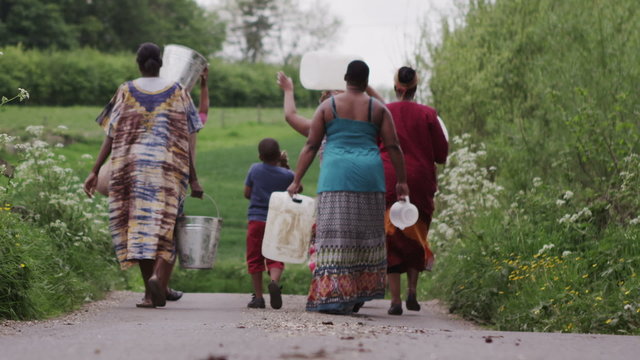 African villagers travel together to find water