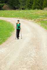 Obraz premium Hiker on road in forest