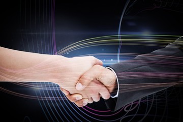 Composite image of close up of a handshake