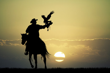 Fototapeta na wymiar man on horse with hawk