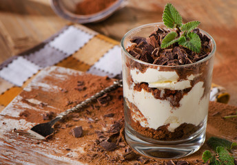 Sweet dessert -Tiramisu cake on wooden table.