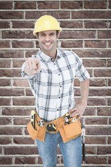 Composite image of handyman pointing over white background