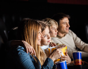Family Of Four Watching Movie In Theater © Tyler Olson