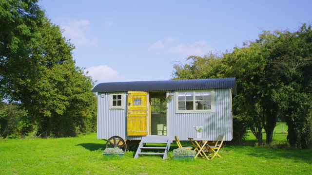 Exterior view of a quaint gypsy caravan on a bright autumn day . No people.